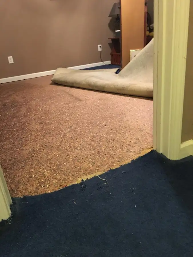 Carpet pad removal revealing water damage during Water Mitigation Services in El Dorado